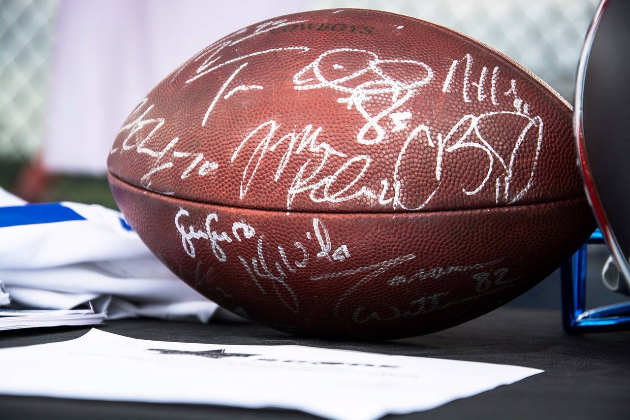 Signed memorabilia, like this signed football, can spark major bid wars at charity auctions.